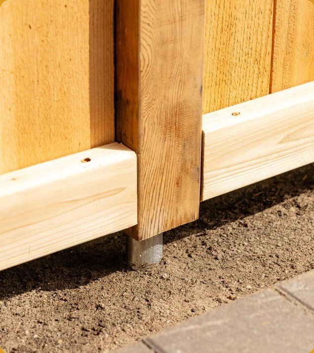 Cedar post on pipe elevated above the ground beside a walkway