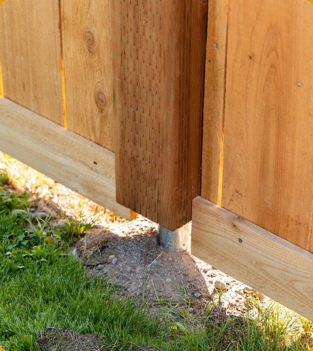 Cedar fence post set on a steel pipe, wood held above the ground