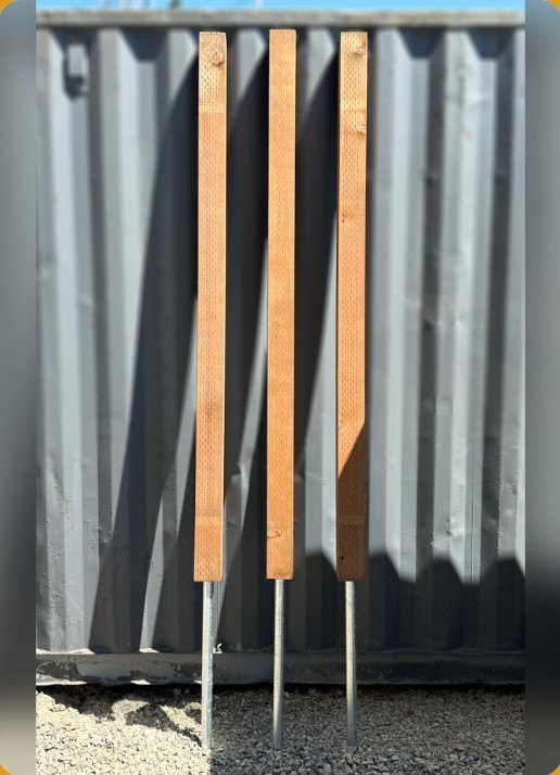 Three jumbo posts on pipe standing ready for install
