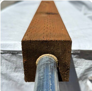 Close-up of the sealed pipe inside the post